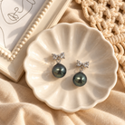 Alba Earrings featuring Tahitian pearl jewellery on a delicate plate, showcasing Pacific jewellery elegance.