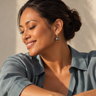 Woman wearing Keiko Earrings with Tahitian pearl jewellery in sunlight, showcasing Pacific and New Zealand jewellery.