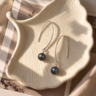 Nalu Earrings featuring Tahitian pearls on a decorative shell, perfect Pacific jewellery for stylish elegance.